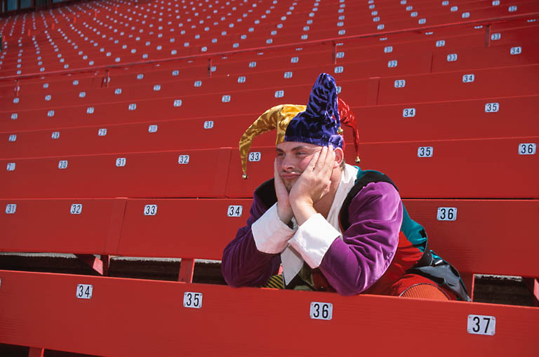 bored-jester-in-empty-stadium-uid